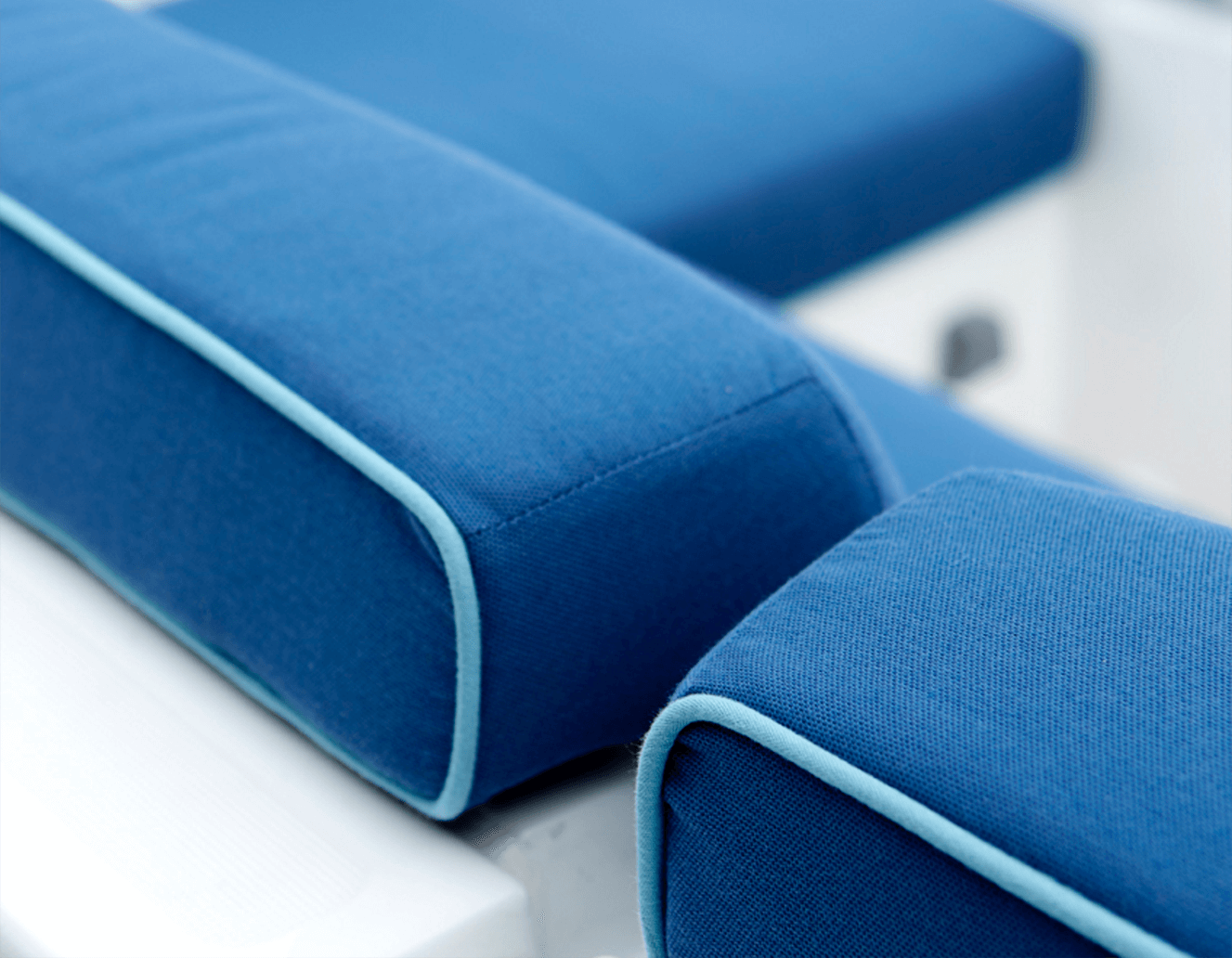 Detail of blue cushions with light blue piping on boat seat cushions