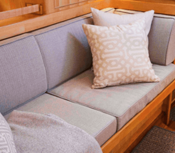A boat cabin has added color and pattern with throw pillows made using Sunbrella fabrics
