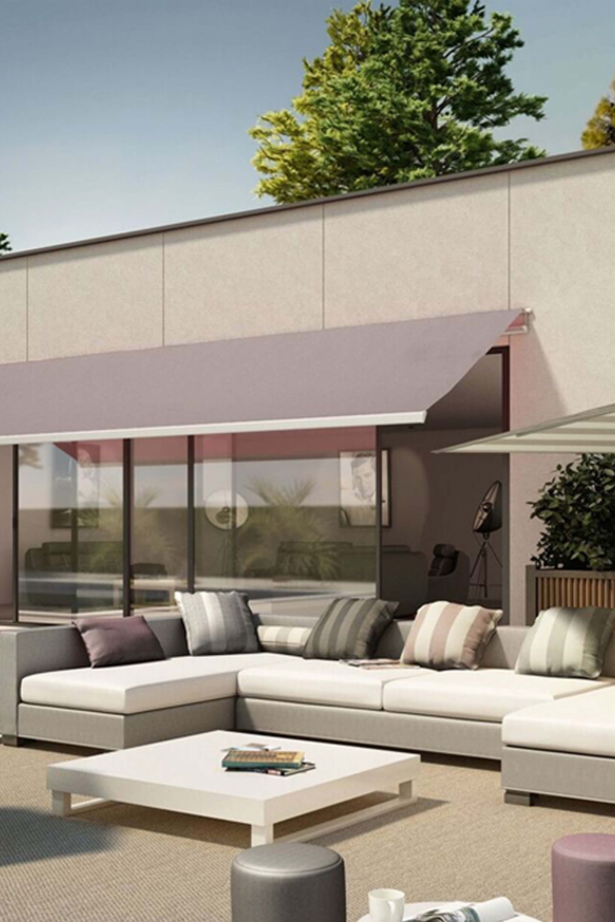 Patio furniture shaded by retractable awning made using Sunbrella fabrics